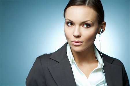 simsearch:632-06779260,k - Beautiful and sexy brunette business woman isolated on clear background with headphones is listen to the music. Foto de stock - Super Valor sin royalties y Suscripción, Código: 400-03953397