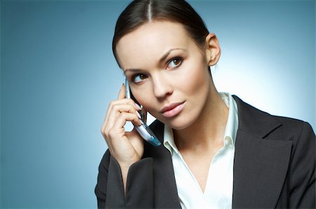 simsearch:400-04164036,k - Beautiful and sexy brunette business woman isolated on clear background is using mobile phone. Foto de stock - Super Valor sin royalties y Suscripción, Código: 400-03953390