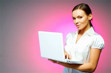 simsearch:400-03954172,k - Beautiful and sexy brunette business woman isolated on clear background with laptop computer Stock Photo - Budget Royalty-Free & Subscription, Code: 400-03953441