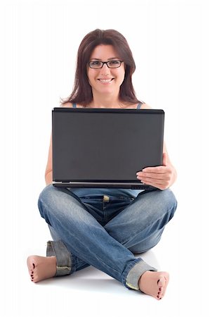 foot in mouth - Beautiful brunette woman with brown hair and glasses smiling and sitting while using a laptop computer. Isolated on white background. Stock Photo - Budget Royalty-Free & Subscription, Code: 400-03964124