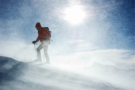 simsearch:400-04359682,k - A lonely backcountry skier reaching the summit of the mountain during a snowstorm, horizontal orientation Stock Photo - Budget Royalty-Free & Subscription, Code: 400-03964163