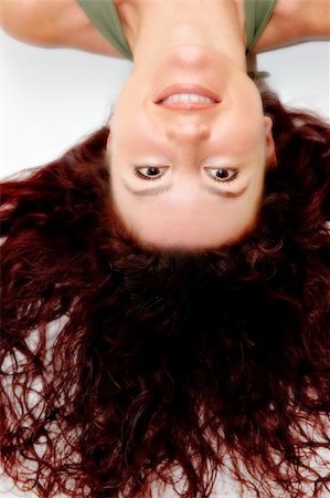 smile with closed lips - Beautiful redhead woman smiling with long curly hair on white background Photographie de stock - Aubaine LD & Abonnement, Code: 400-03964179