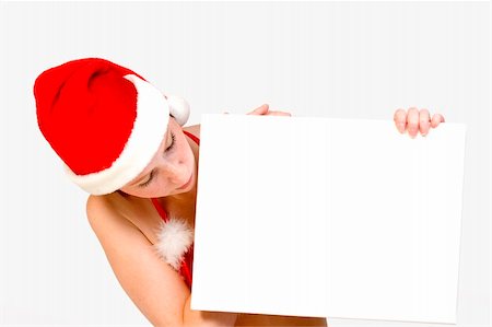 simsearch:693-07444529,k - Beautifull girl in christmas bikini and with christmas hat is hlding up a white sign for copy space. With background clipping path for your convenience Stock Photo - Budget Royalty-Free & Subscription, Code: 400-03964546
