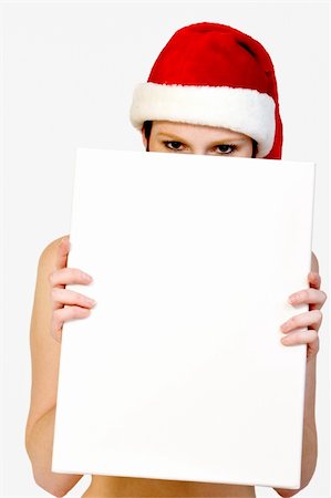 simsearch:693-07444529,k - Beautifull girl in christmas bikini and with christmas hat is hlding up a white sign for copy space. With background clipping path for your convenience Stock Photo - Budget Royalty-Free & Subscription, Code: 400-03964548