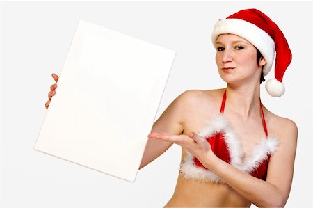 simsearch:693-07444529,k - Beautifull girl in christmas bikini and with christmas hat is hlding up a white sign for copy space. With background clipping path for your convenience Stock Photo - Budget Royalty-Free & Subscription, Code: 400-03964550