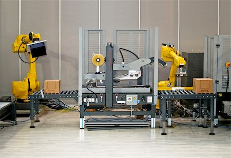 robotic arm - Two robotic hands simultaneous work at packaging line Stock Photo - Budget Royalty-Free & Subscription, Code: 400-03964576