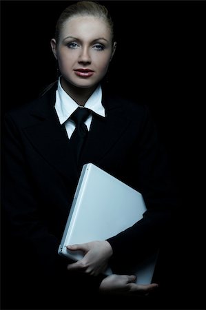 simsearch:400-03954172,k - Beautiful business woman wearing black tie and jacket isolated on black background with laptop computer Stock Photo - Budget Royalty-Free & Subscription, Code: 400-03964977