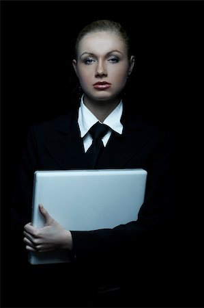 simsearch:400-03954172,k - Beautiful business woman wearing black tie and jacket isolated on black background with laptop computer Stock Photo - Budget Royalty-Free & Subscription, Code: 400-03964978