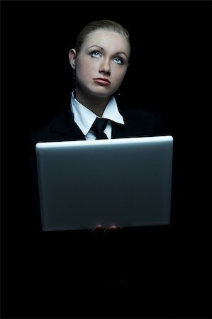 simsearch:400-03954172,k - Beautiful business woman wearing black tie and jacket isolated on black background with laptop computer Stock Photo - Budget Royalty-Free & Subscription, Code: 400-03964980
