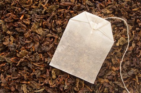 Tea Bag laying on a bed of tea leaves Stock Photo - Budget Royalty-Free & Subscription, Code: 400-03964998