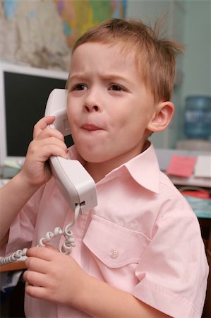 The boy speaks by phone in working hours Stockbilder - Microstock & Abonnement, Bildnummer: 400-03965275