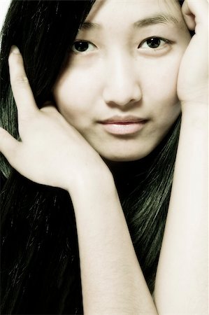 Portrait of an Asian model holding her long hair Photographie de stock - Aubaine LD & Abonnement, Code: 400-03965358