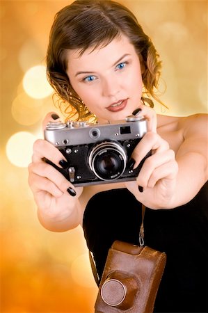 simsearch:400-03965656,k - a glamorous girl in the evening dress holding a camera Photographie de stock - Aubaine LD & Abonnement, Code: 400-03965644