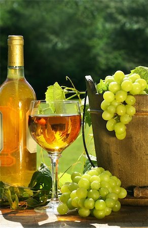 White wine with bottle and grapes on a rustic table Stock Photo - Budget Royalty-Free & Subscription, Code: 400-03965752