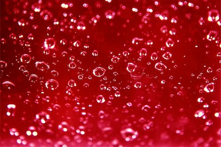 sparkling rain drops on glass against a red background Fotografie stock - Microstock e Abbonamento, Codice: 400-03966130