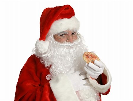 simsearch:400-04636742,k - Isolated Santa Clause eating a Christmas cookie. Foto de stock - Royalty-Free Super Valor e Assinatura, Número: 400-03966976