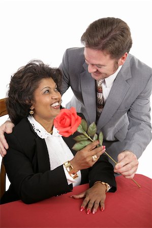 simsearch:400-03967457,k - An attractive interracial couple on a date.  He surprises her with a red rose. Foto de stock - Royalty-Free Super Valor e Assinatura, Número: 400-03966971