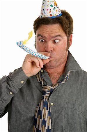 A man at a party wearing a party hat and blowing on a noisemaker. Stock Photo - Budget Royalty-Free & Subscription, Code: 400-03967072