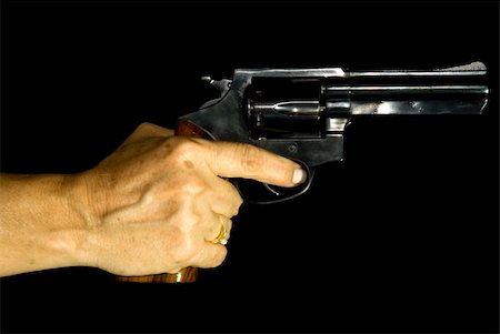 Cropped shot of a female hand holding a .38 calibre revolver Stock Photo - Budget Royalty-Free & Subscription, Code: 400-03967104