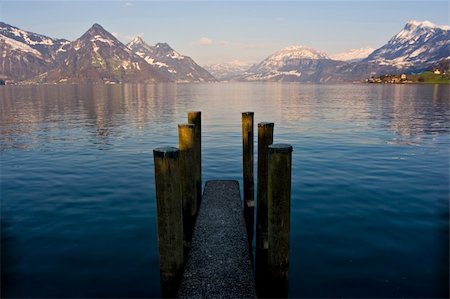 simsearch:862-03365270,k - Empty dock in calm lake with mountains in the horizon. Buochs, Switzerland. Stockbilder - Microstock & Abonnement, Bildnummer: 400-03968266