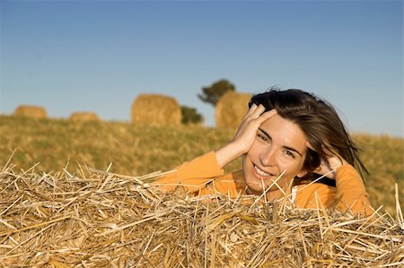 simsearch:400-04123668,k - Beautiful woman in a field with hay bales Stock Photo - Budget Royalty-Free & Subscription, Code: 400-03968275