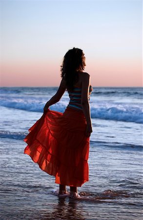 Woman holding the skirt at the sunset Stock Photo - Budget Royalty-Free & Subscription, Code: 400-03968306