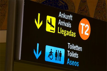 Arrivals and toilets sign panels in airport, Malaga. Foto de stock - Super Valor sin royalties y Suscripción, Código: 400-03968652