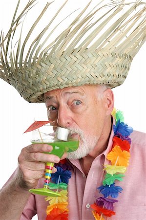 simsearch:400-03969432,k - A senior man on a tropical vacation drinking a margarita with a surprised expression.  Isolated. Stock Photo - Budget Royalty-Free & Subscription, Code: 400-03969180