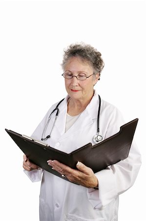 simsearch:400-04117274,k - A mature female doctor reviewing a medical chart.  Isolated on white. Photographie de stock - Aubaine LD & Abonnement, Code: 400-03969249