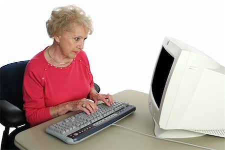 A senior lady confused by the computer.  Screen intentionally blank ready for content. Stock Photo - Budget Royalty-Free & Subscription, Code: 400-03969318