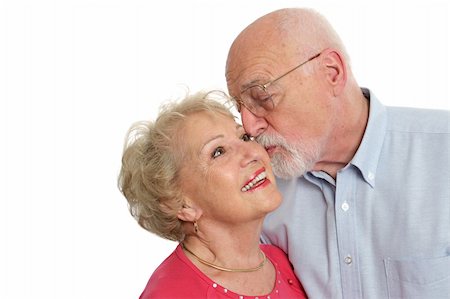 simsearch:400-03969319,k - An attractive senior man kissing his beautiful wife on the cheek.  Isolated with room for text. Stock Photo - Budget Royalty-Free & Subscription, Code: 400-03969319