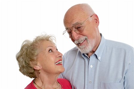 simsearch:400-03969319,k - A happy senior couple sharing a private joke together.  She is wearing a hearing aid.  Isolated. Stock Photo - Budget Royalty-Free & Subscription, Code: 400-03969327