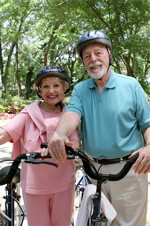 simsearch:400-03969319,k - An attractive senior couple bicycling with helmets on. Stock Photo - Budget Royalty-Free & Subscription, Code: 400-03969333
