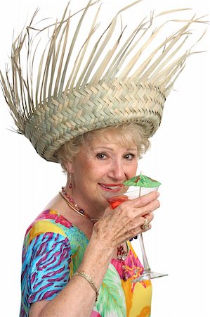 simsearch:862-03808758,k - A beautiful senior lady enjoying a tropical cocktail on a cruise.  Isolated. Photographie de stock - Aubaine LD & Abonnement, Code: 400-03969347