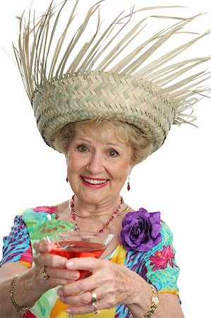 simsearch:862-03808758,k - A beautiful senior lady on vacation making a toast with her tropical cocktail.  Isolated Photographie de stock - Aubaine LD & Abonnement, Code: 400-03969341