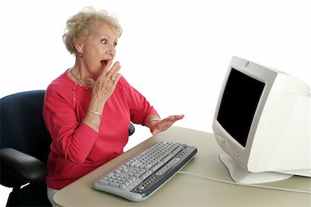 A senior woman viewing shocking internet content.  Screen intentionally blank, ready for text or image. Stock Photo - Budget Royalty-Free & Subscription, Code: 400-03969353