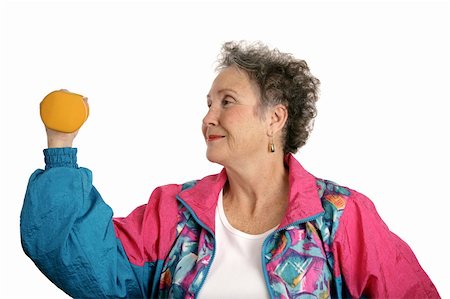 A senior woman in a tracksuit working out with freeweights.  Isolated on white. Stock Photo - Budget Royalty-Free & Subscription, Code: 400-03969399