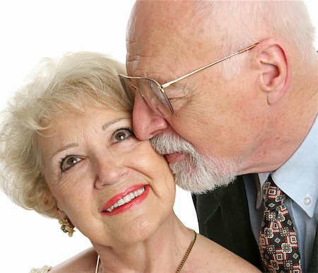 simsearch:400-03969319,k - Closeup of a loving senior man gives his beautiful wife a kiss on the cheek. Stock Photo - Budget Royalty-Free & Subscription, Code: 400-03969418