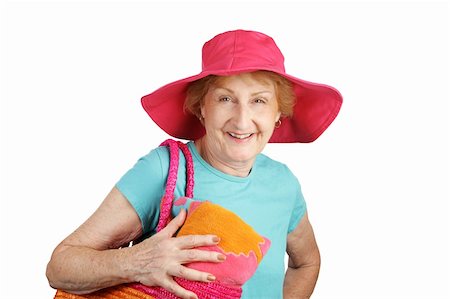 An attractive senior lady with her towel, beach bag and sun hat.  Isolated on white. Stock Photo - Budget Royalty-Free & Subscription, Code: 400-03969451