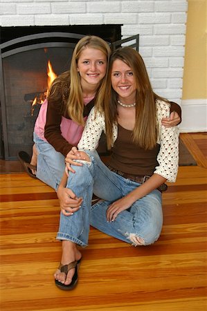 fireplace autumn - Beautiful blond sisters sitting beside the fireplace. Stock Photo - Budget Royalty-Free & Subscription, Code: 400-03969707