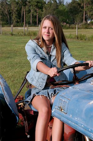 A beautiful blond country girl driving a tractor. Stock Photo - Budget Royalty-Free & Subscription, Code: 400-03969709