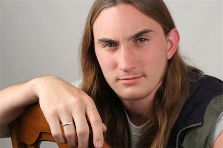 a handsome young man with long hair in a casual pose Stock Photo - Budget Royalty-Free & Subscription, Code: 400-03969725