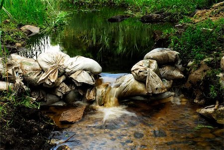 Sandbags create small waterfall in Destruction Brook in Dartmouth, MA Stockbilder - Microstock & Abonnement, Bildnummer: 400-03969895