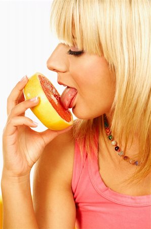 simsearch:693-06020240,k - Happy beautiful women with holding and licking grapefruit Photographie de stock - Aubaine LD & Abonnement, Code: 400-03960182