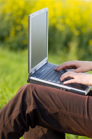 simsearch:400-08997106,k - Woman working with a laptop on her knees outside in a meadow. Stock Photo - Budget Royalty-Free & Subscription, Code: 400-03960389