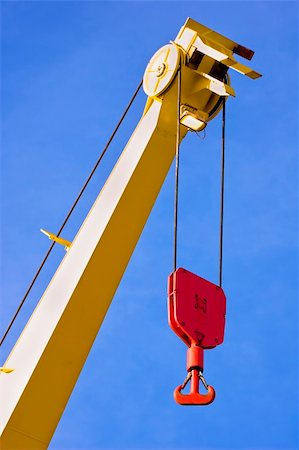 simsearch:632-06404737,k - Yellow crane with red hook against blue sky Stock Photo - Budget Royalty-Free & Subscription, Code: 400-03960909