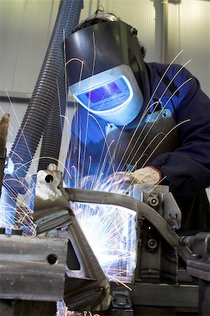 Manual welder welding in an industrial environment Stock Photo - Budget Royalty-Free & Subscription, Code: 400-03961086