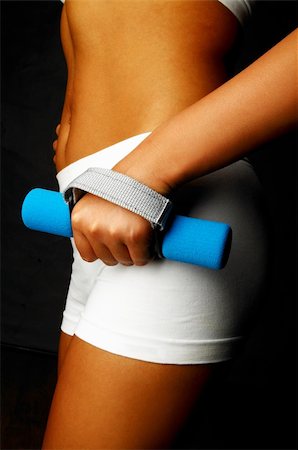 simsearch:695-05778665,k - Woman's body part with fitness dumbell Photographie de stock - Aubaine LD & Abonnement, Code: 400-03961432