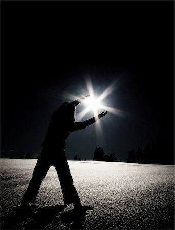 A woman reaches out as if to hold the sun or a star. Stock Photo - Budget Royalty-Free & Subscription, Code: 400-03962161