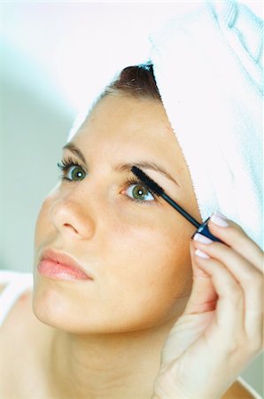 Pretty young brunette girl doing morning makeup. Stock Photo - Budget Royalty-Free & Subscription, Code: 400-03962727